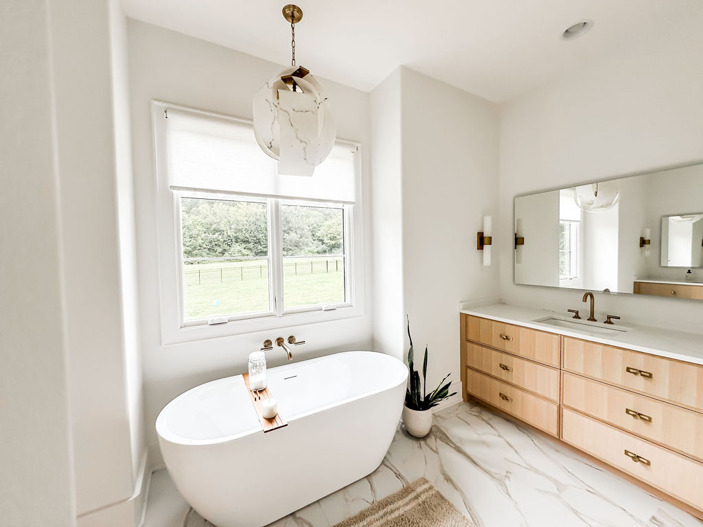 Primary bathroom, freestanding tub, marble floors, natural wood double vanity