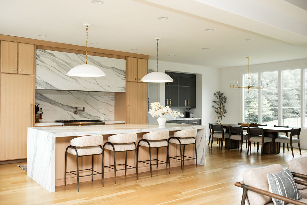 Kitchen and dining, open layout, marble backsplash, brass pendants