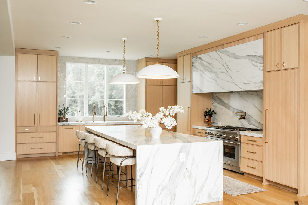 Kitchen transformation, marble waterfall island, brass hardware, natural wood cabinetry